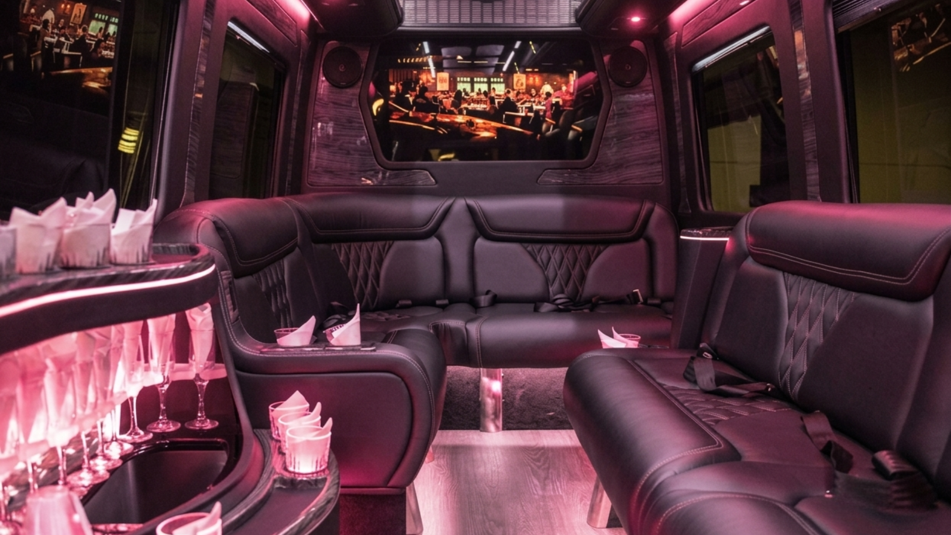 Party bus interior — wraparound lounge seating and LED party lighting